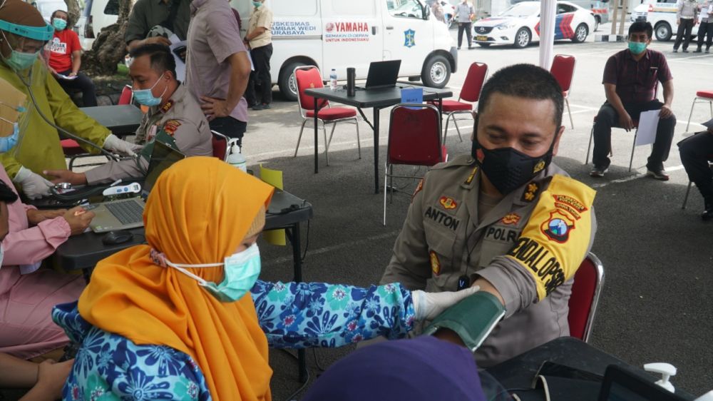 Petugas Nakes sedang memvaksin Polisi di lapangan Polrestabes