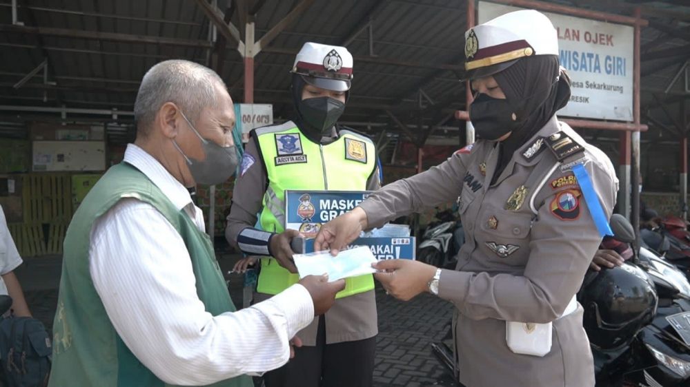 Polwan Satlantas Polres Gresik saat berbagi masker dan edukasi Protokol Kesehatan